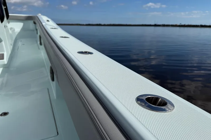 Slide: The Image of 2025 Front Runner 37 Catamaran deck view with sleek design and ocean backdrop. - 53