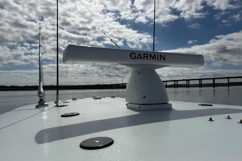Slide: The Image of 2025 Front Runner 37 Catamaran with Garmin radar, under a cloudy sky on calm waters. - 55