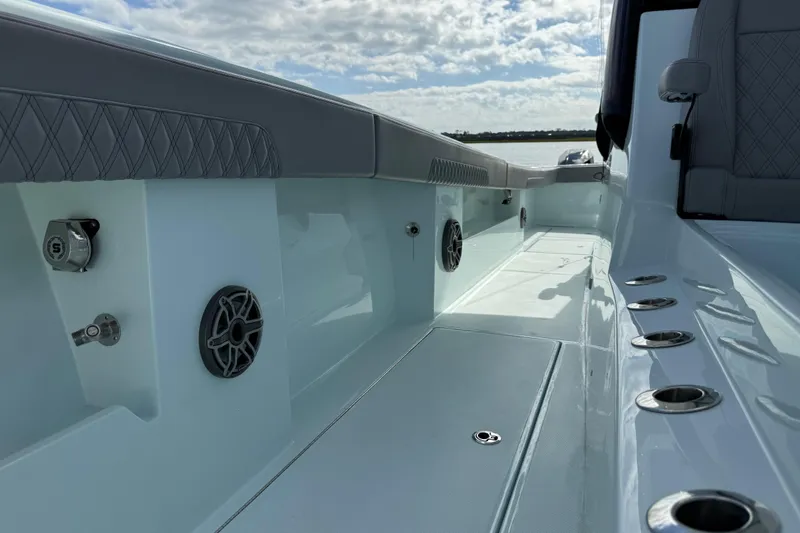 Slide: The Image of 2025 Front Runner 37 Catamaran interior with sleek design, speakers, and rod holders. - 57