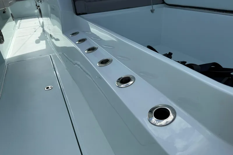 Slide: The Image of 2025 Front Runner 37 Catamaran deck with rod holders and sleek design. - 58