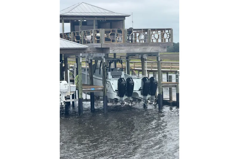 Slide: The Image of 2025 Front Runner 37 Catamaran docked with multiple outboard engines. - 7