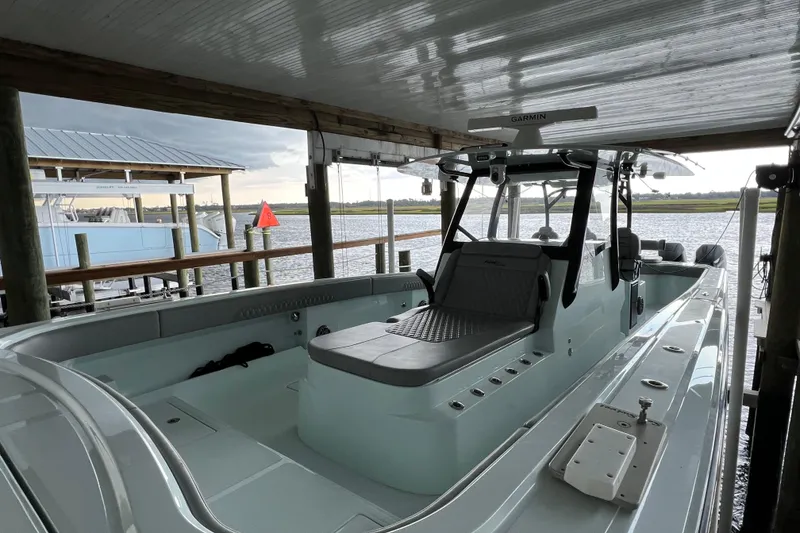 Slide: The Image of 2025 Front Runner 37 Catamaran docked under a covered pier, showcasing sleek design. - 9