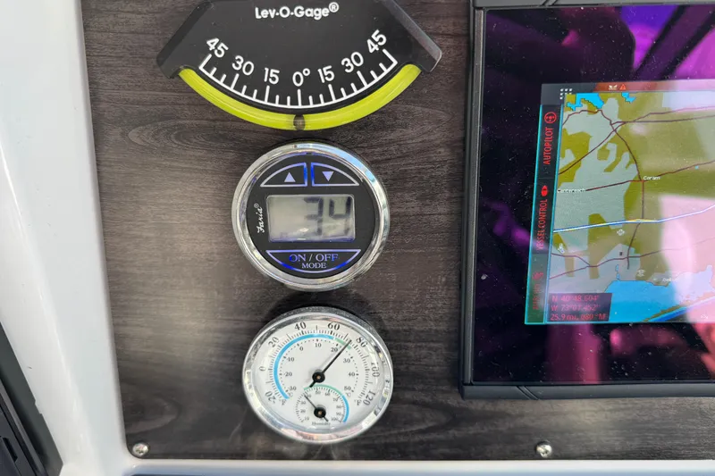 Slide: The Image of Dashboard of 2020 Rinker 320 EX boat with gauges and navigation screen. - 12