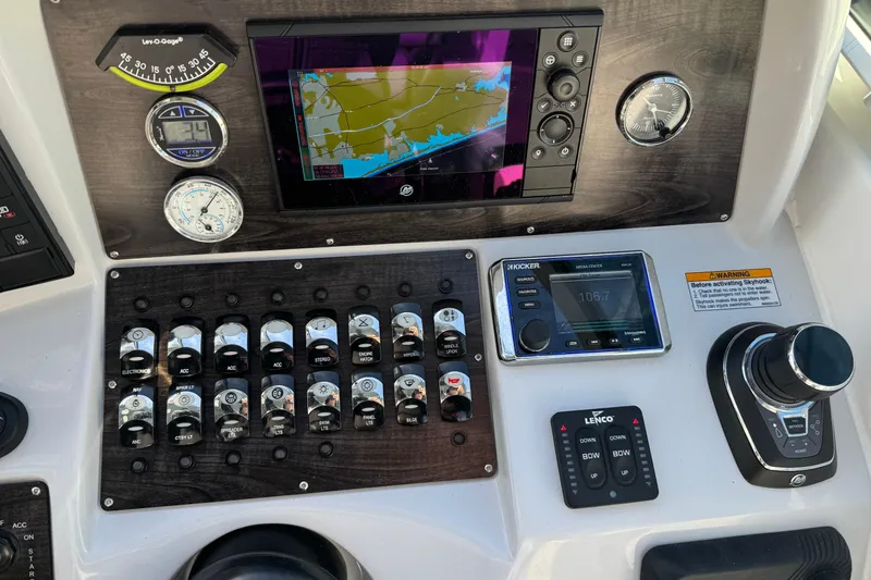 Slide: The Image of Control panel of a 2020 Rinker 320 EX boat with navigation and audio systems. - 14