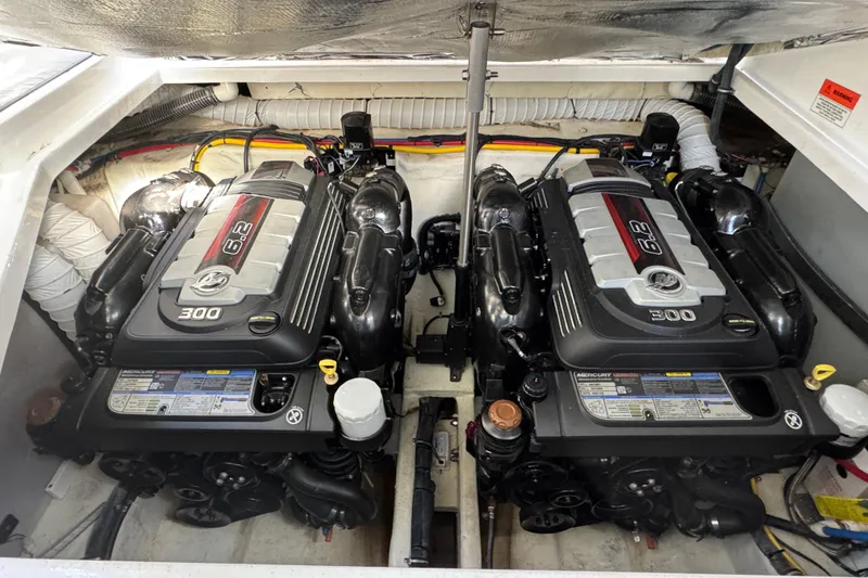 Slide: The Image of Twin Mercury 6.2L engines in a 2020 Rinker 320 EX boat engine compartment. - 3