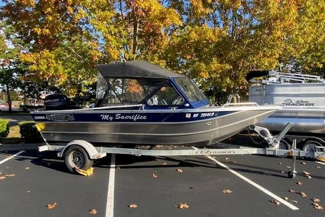 The Image of 2016 Thunderjet 186ECO boat on trailer, parked under autumn trees. - 1