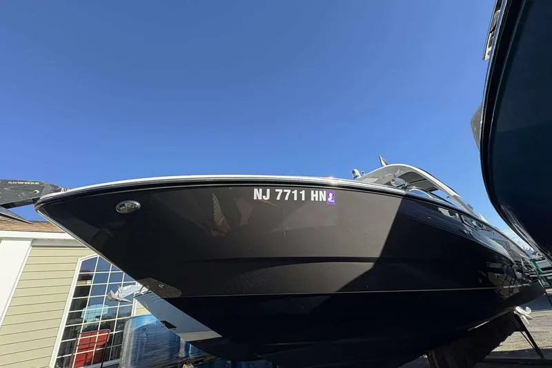 The Image of 2020 Monterey 305SS Super Sport boat with registration NJ 7711 HN, under clear blue sky. - 1