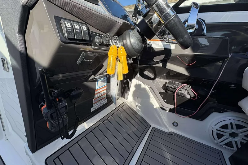 Slide: The Image of Cockpit of 2020 Monterey 305SS Super Sport boat with steering wheel and controls. - 12