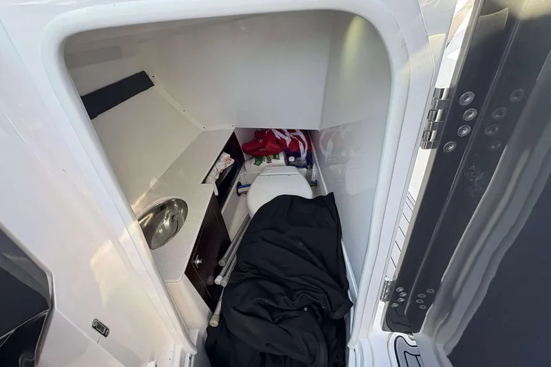 Slide: The Image of 2020 Monterey 305SS Super Sport boat interior with compact sink and storage area. - 21