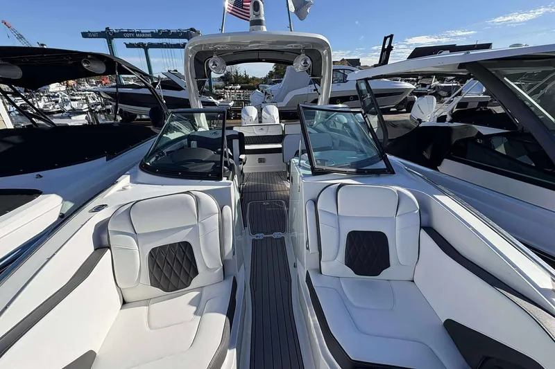 Slide: The Image of 2020 Monterey 305SS Super Sport boat interior with luxurious seating at a marina. - 7