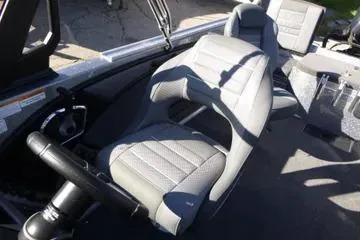 Slide: The Image of 2026 Ranger 2080MS boat interior with gray seating and steering wheel. - 85