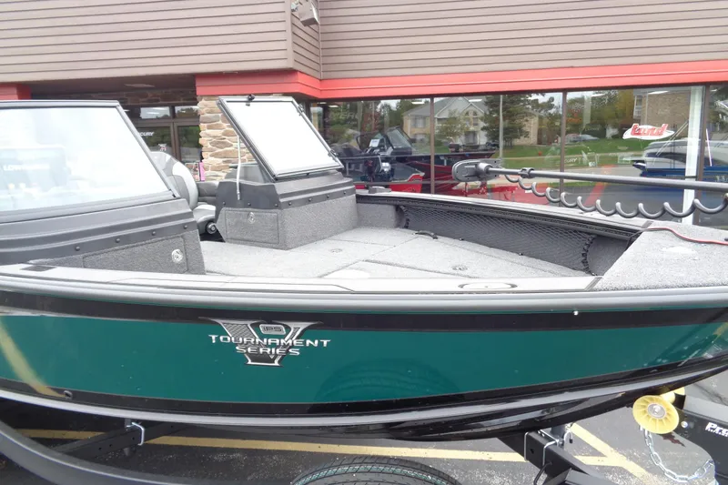Slide: The Image of 2026 Lund 2175 Pro-V Tournament Series boat, green exterior, displayed outdoors. - 10