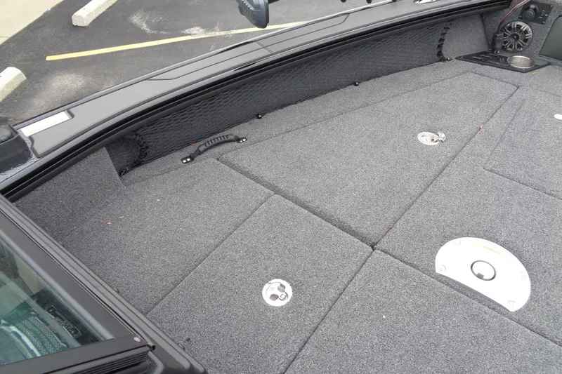 Slide: The Image of 2026 Lund 2175 Pro-V boat deck with carpeted surface and storage compartments. - 13