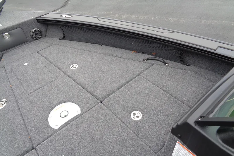 Slide: The Image of 2026 Lund 2175 Pro-V boat interior with carpeted deck and storage compartments. - 14