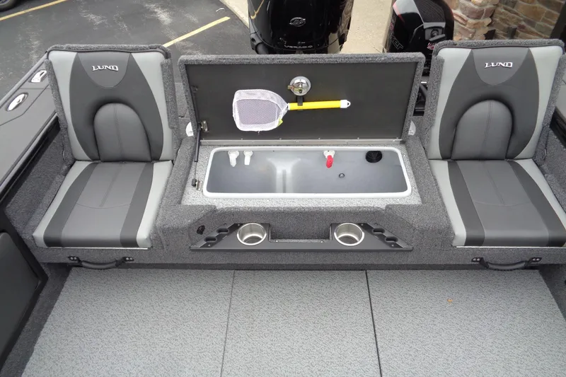 Slide: The Image of 2026 Lund 2175 Pro-V boat interior with seating and storage compartments. - 27