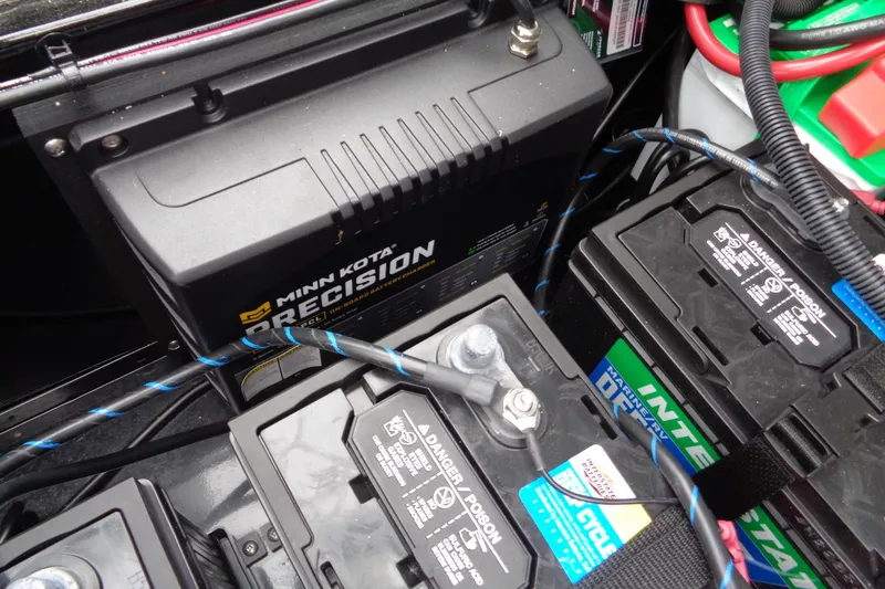 Slide: The Image of Minn Kota Precision charger and batteries in 2026 Lund 2175 Pro-V boat. - 31