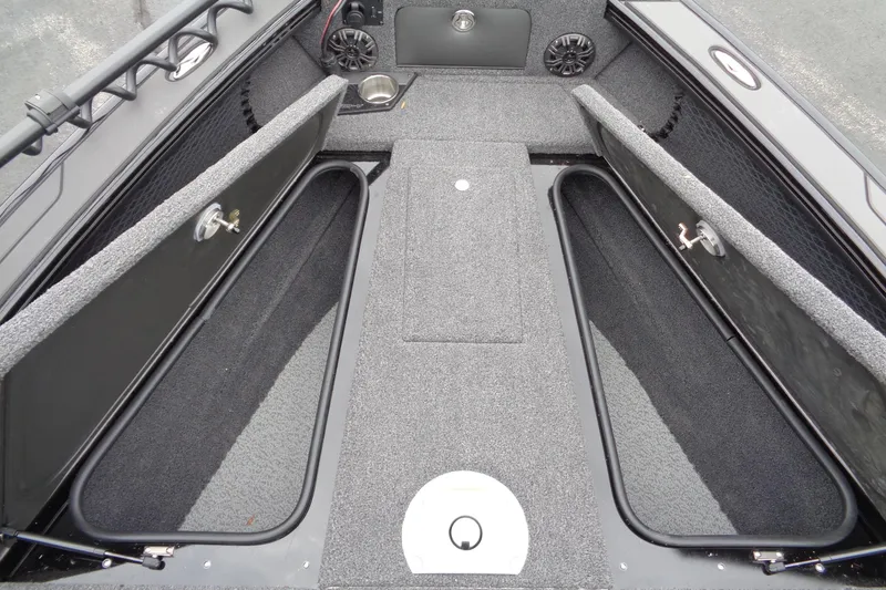 Slide: The Image of 2026 Lund 2175 Pro-V boat interior with open storage compartments and speakers. - 34