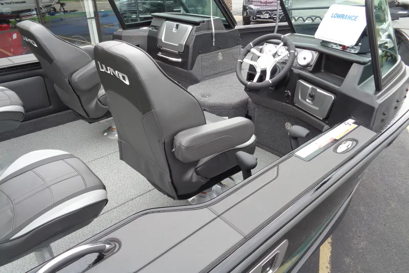 Slide: The Image of 2026 Lund 2175 Pro-V boat interior with steering wheel and seating. - 40