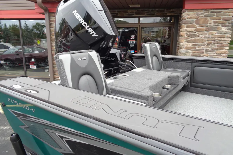 Slide: The Image of 2026 Lund 2175 Pro-V boat with Mercury engine, featuring comfortable seating and modern design. - 8