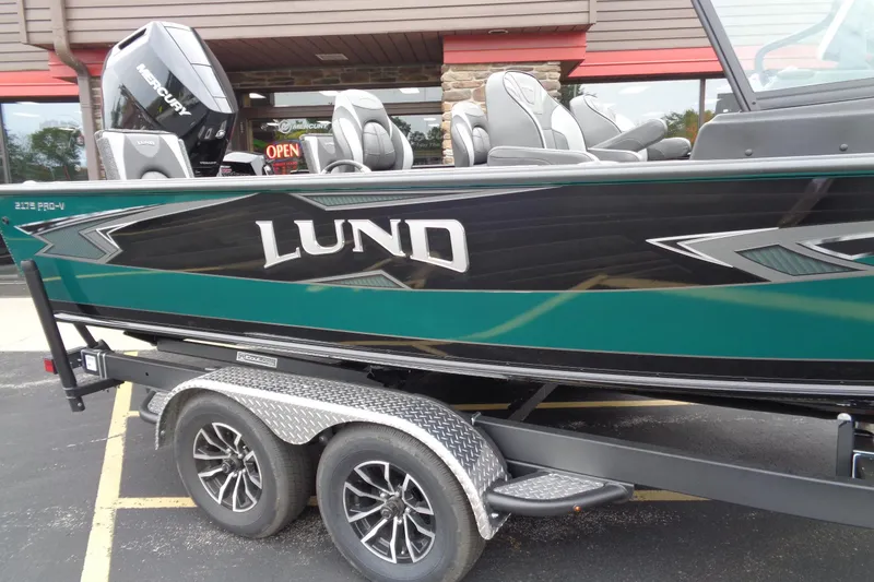 Slide: The Image of 2026 Lund 2175 Pro-V boat on trailer, featuring sleek design and Mercury engine. - 9