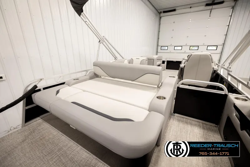 Slide: The Image of 2026 Avalon VEN85 VRB pontoon boat interior with plush seating in a spacious garage. - 25