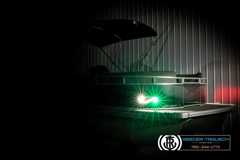 Slide: The Image of 2026 Avalon VEN85 VRB pontoon boat with illuminated navigation lights in a dimly lit setting. - 4