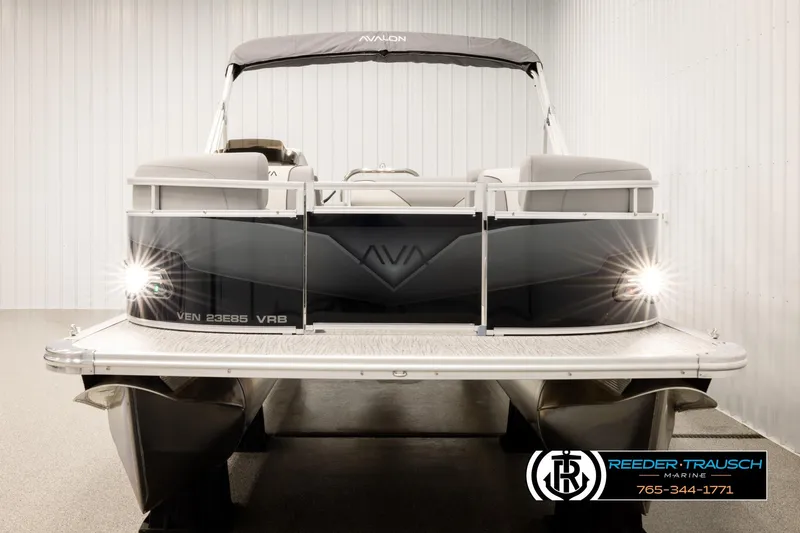 Slide: The Image of 2026 Avalon VEN85 VRB pontoon boat with lights on, displayed indoors at Reeder-Trausch Marine. - 8