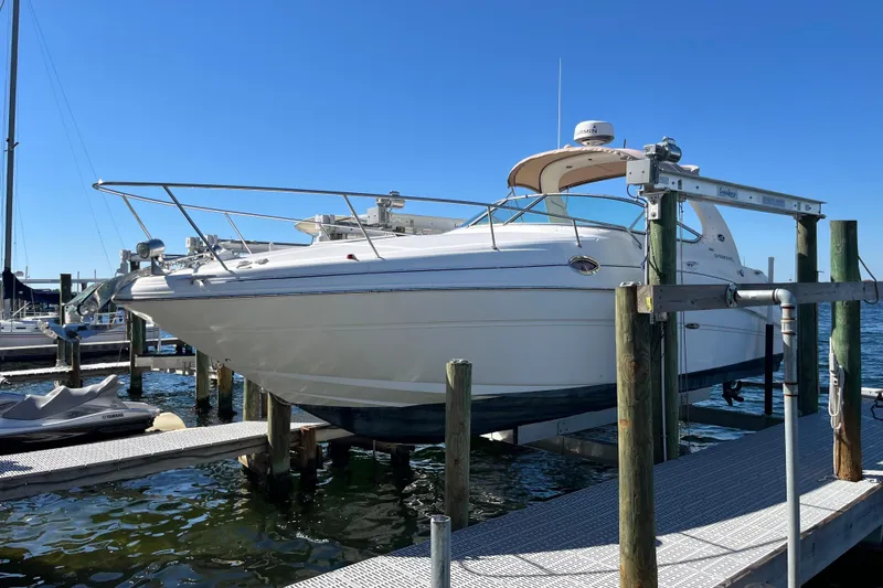 Slide: The Image of 2001 Sea Ray 280 Sundancer docked at marina under clear blue sky. - 2