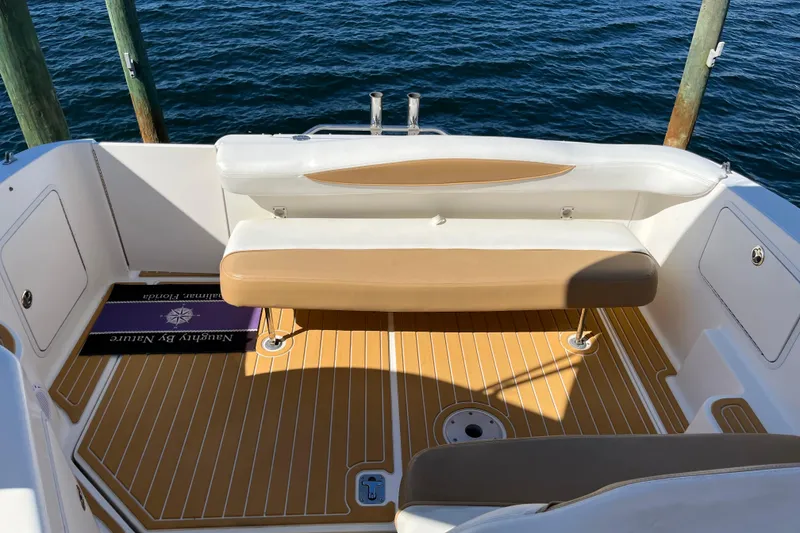 Slide: The Image of 2001 Sea Ray 280 Sundancer boat interior with tan seating and teak flooring. - 3