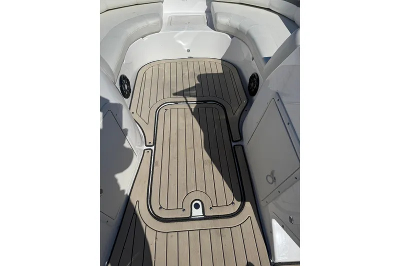 Slide: The Image of 2022 Hurricane SunDeck 187 IO boat interior with cushioned seating and wood-patterned flooring. - 12