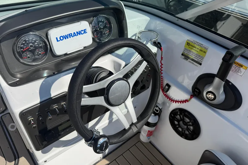 Slide: The Image of 2022 Hurricane SunDeck 187 IO boat dashboard with steering wheel and controls. - 14