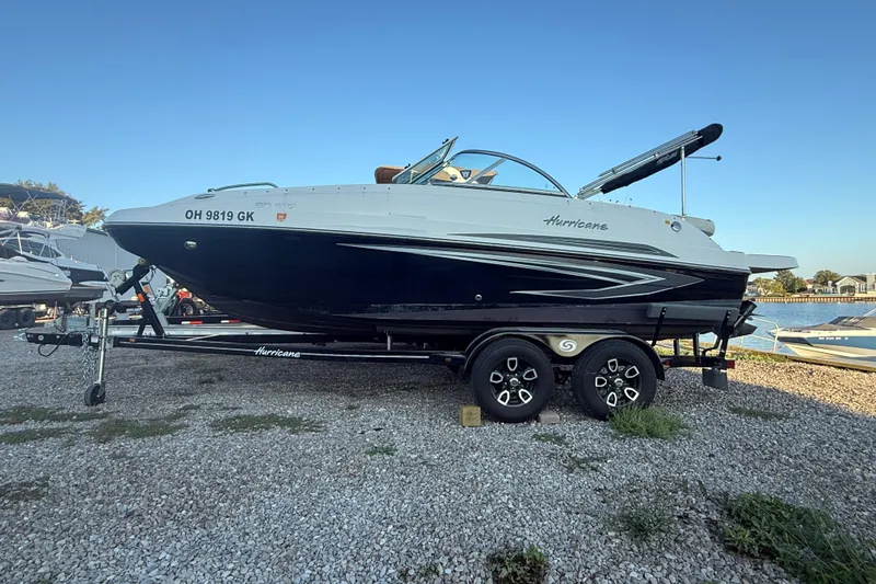 Slide: The Image of 2022 Hurricane SunDeck 187 IO boat on trailer by the water. - 6