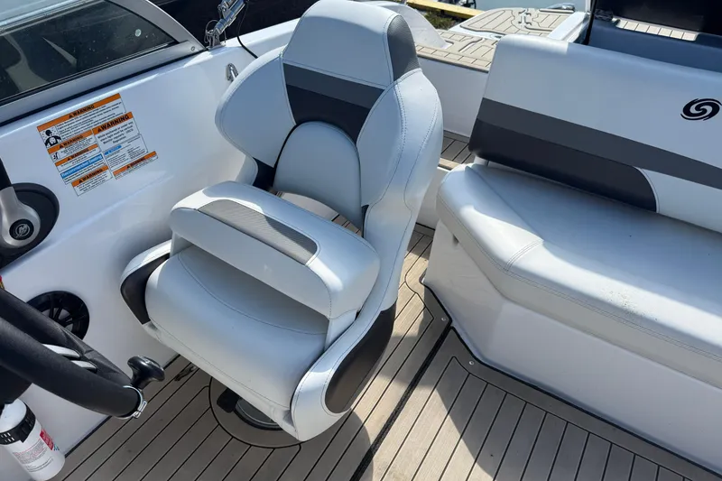 Slide: The Image of 2022 Hurricane SunDeck 187 IO boat interior with white captain's chair and seating. - 9