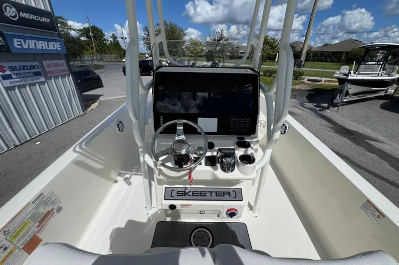 Slide: The Image of 2026 Skeeter SX2350 boat dashboard with steering wheel and controls, outdoor dealership setting. - 15