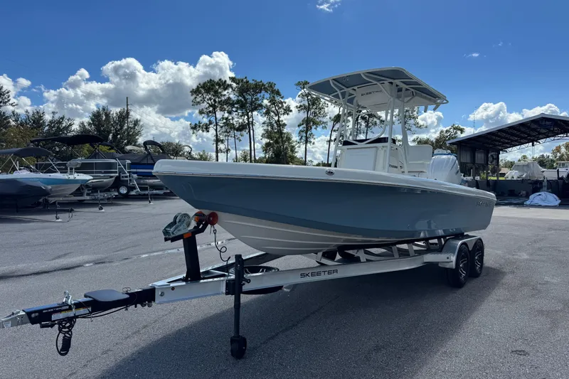 Slide: The Image of 2026 Skeeter SX2350 boat on trailer under clear blue sky. - 4