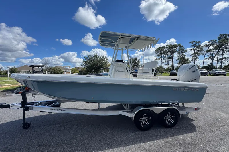 Slide: The Image of 2026 Skeeter SX2350 boat on trailer under blue sky with clouds. - 5