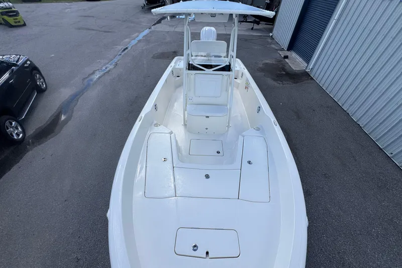 Slide: The Image of 2026 Skeeter SX2350 boat, white deck, parked near a metal building. - 6