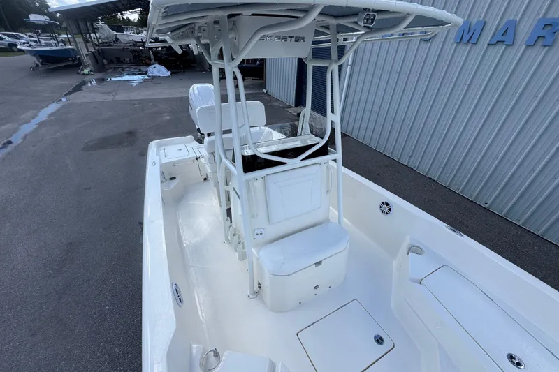 Slide: The Image of 2026 Skeeter SX2350 boat with T-top, white interior, docked at marina. - 8