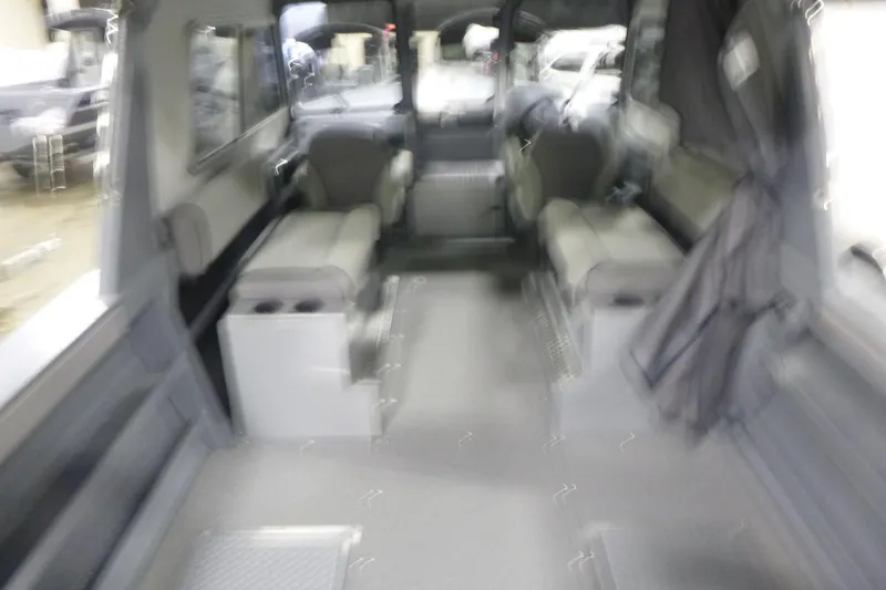 Slide: The Image of 2026 KingFisher 2425 Escape HT interior seating with cup holders, featuring sleek design. - 13