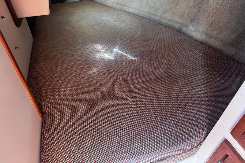 Slide: The Image of Interior cabin bed of 1984 Hunter 37 Cutter sailboat with patterned upholstery. - 21