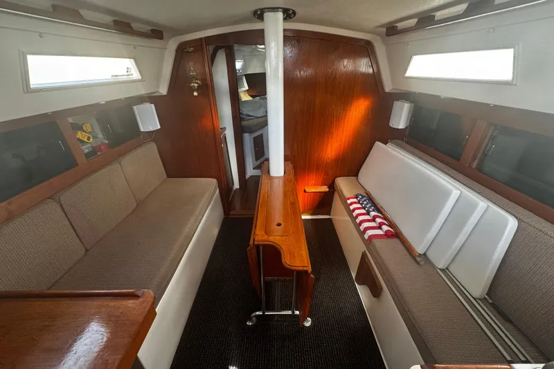 Slide: The Image of Interior of 1984 Hunter 37 Cutter sailboat with cozy seating and wooden accents. - 23