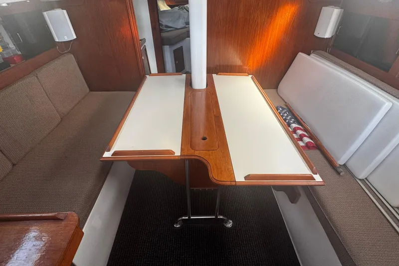 Slide: The Image of Interior of 1984 Hunter 37 Cutter sailboat with wooden table and cushioned seating. - 26