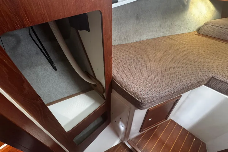 Slide: The Image of Interior of 1984 Hunter 37 Cutter sailboat with wooden accents and cushioned seating. - 30