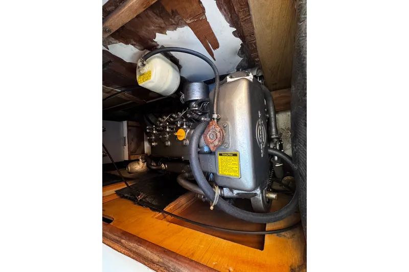 Slide: The Image of Engine compartment of a 1984 Hunter 37 Cutter sailboat, showcasing mechanical components. - 32