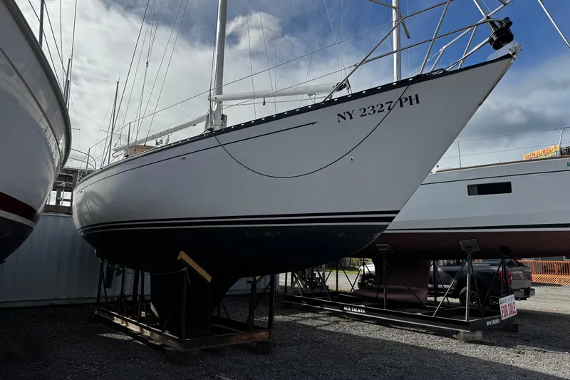 Slide: The Image of 1984 Hunter 37 Cutter sailboat on dry dock, NY registration visible. - 35