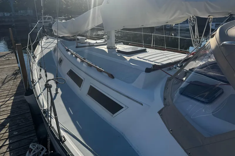 Slide: The Image of 1984 Hunter 37 Cutter sailboat docked, showcasing deck and rigging details. - 5