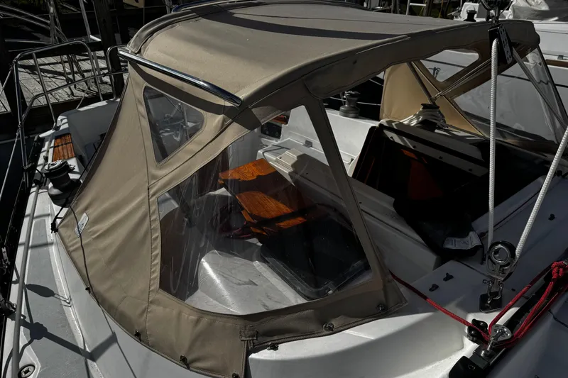 Slide: The Image of 1984 Hunter 37 Cutter sailboat with beige canopy and visible cockpit area. - 16