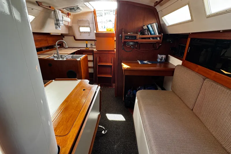 Slide: The Image of Interior of 1984 Hunter 37 Cutter sailboat with cozy seating and wooden cabinetry. - 18