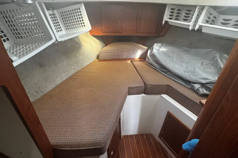 Slide: The Image of Cozy cabin interior of 1984 Hunter 37 Cutter sailboat with storage baskets and cushions. - 29