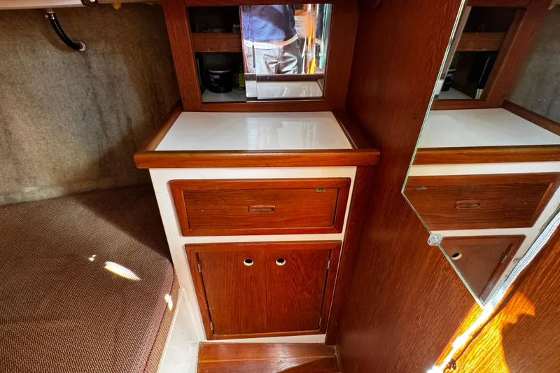Slide: The Image of Interior of 1984 Hunter 37 Cutter sailboat with wooden cabinetry and mirror. - 33